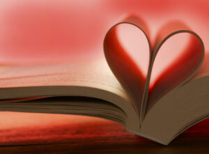 Open book with pages folded in make a heart shape