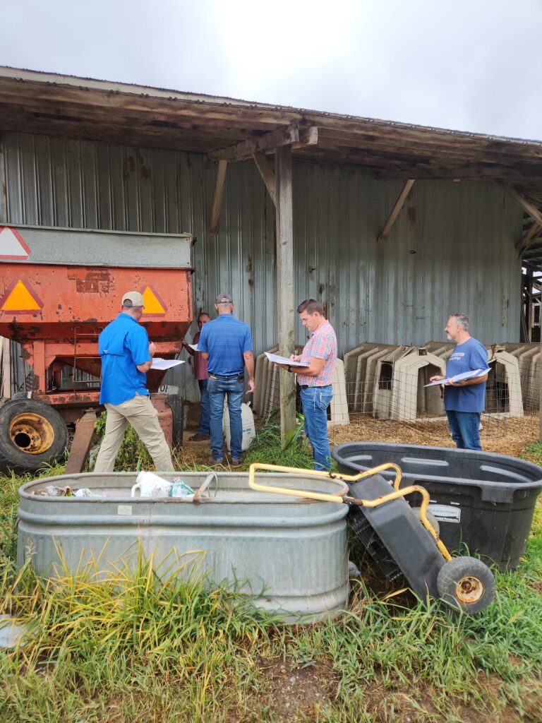 A team including Dr. David Berry (right) evaluates a farm.