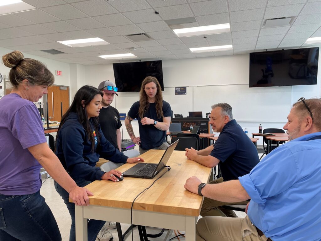 At the end of spring semester, Ashley Stanley (from left), Briana Wood, Joseph Rains, Nat Stuart, Dr. David Berry and Adam O'Neal work on preparing notes for student missions in a new course launching in spring 2025.