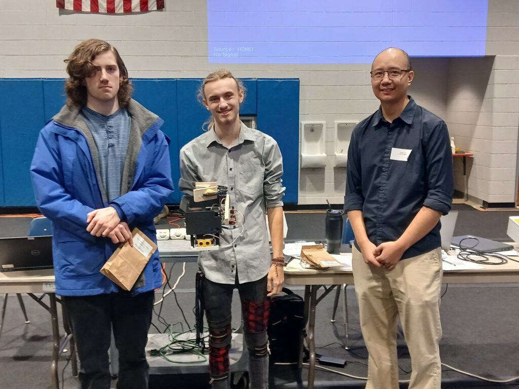 Ben Bellino and Nick Powers, here with Dr. Arnold Yim of the Math Department, were the winning college team, called Fishcakes.