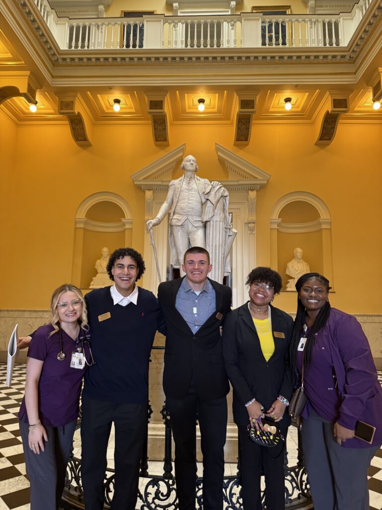 Virginia Western students (from left) Grace Dillon, Yassine Abdelkader, Joshua Hawks, Chanell Johnson and Uleksis Williams in the Rotunda at the Virginia State Capitol, pictured with a statue of George Washington.