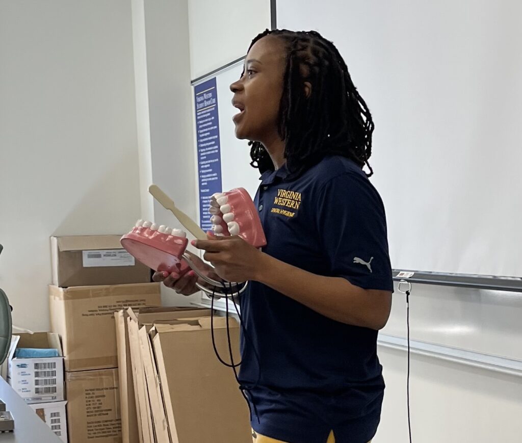 Marlana Thomas, Dental Hygiene Program Head, gives a demonstration at the summit.