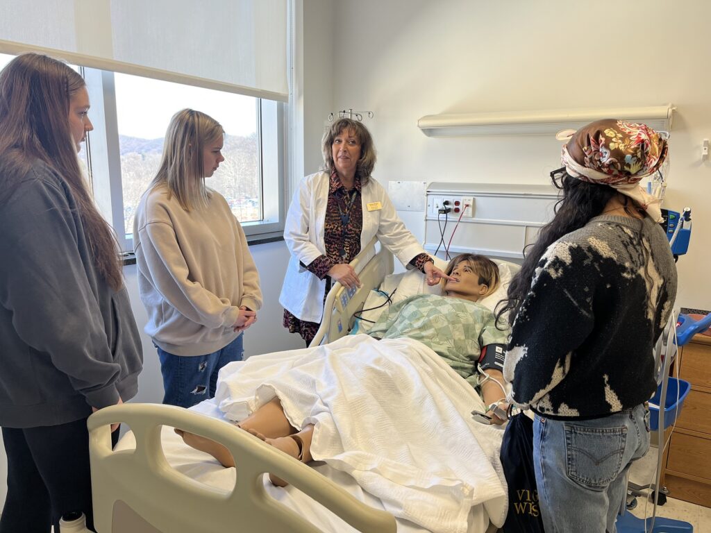 Nursing faculty member Robin Wood demonstrates a simulator to Roanoke City healthcare students.