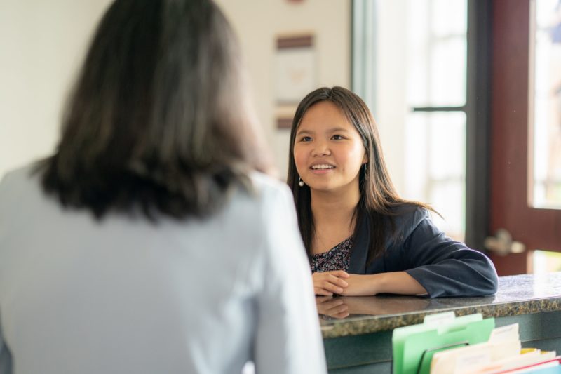 Staff member helping student